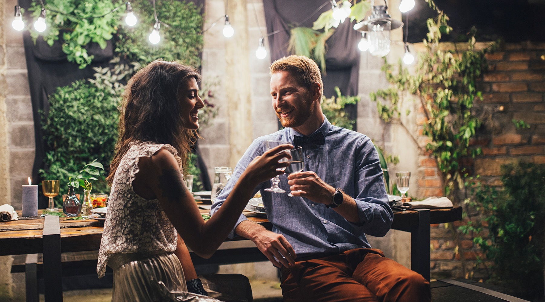 a couple with drinks in an outdoor environment