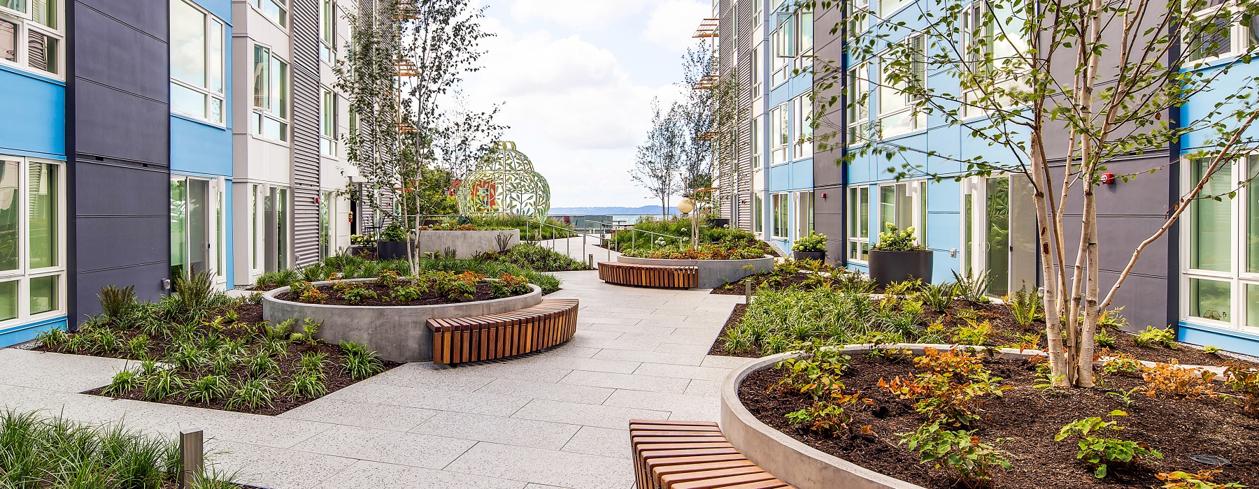 courtyard with benches around large planters