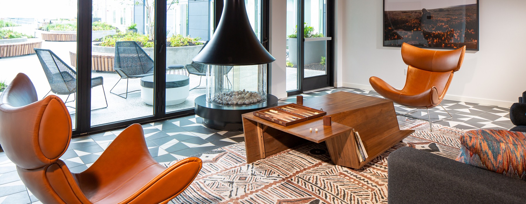 fireside seating in clubhouse with floor-to-ceiling windows
