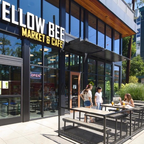 Yellow Bee Market and Cafe store front with customers