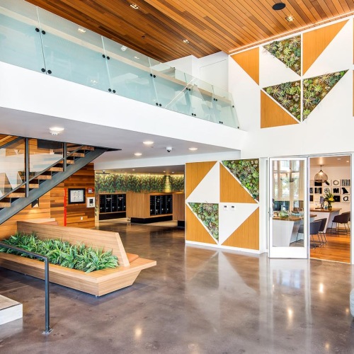 large lobby with a staircase and access to mail center and leasing office